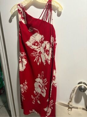 Red dress with white flowers. Has a strap for one shoulder. Very comfy
